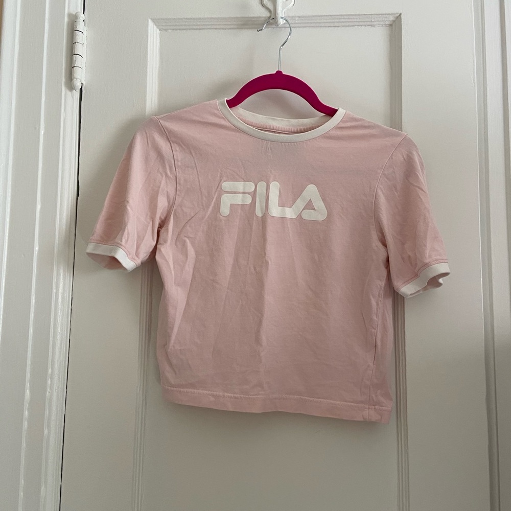 Cropped pink fila top with white accents.